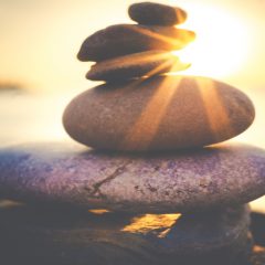 rocks balanced on beach in the sun